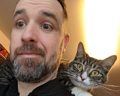 My cat, Billie, lounging on my shoulders